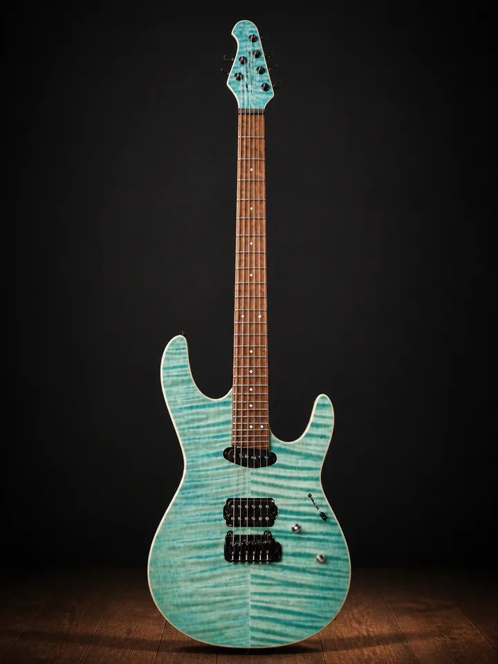 Aqua figured-top Caldwell custom guitar on a professional studio background