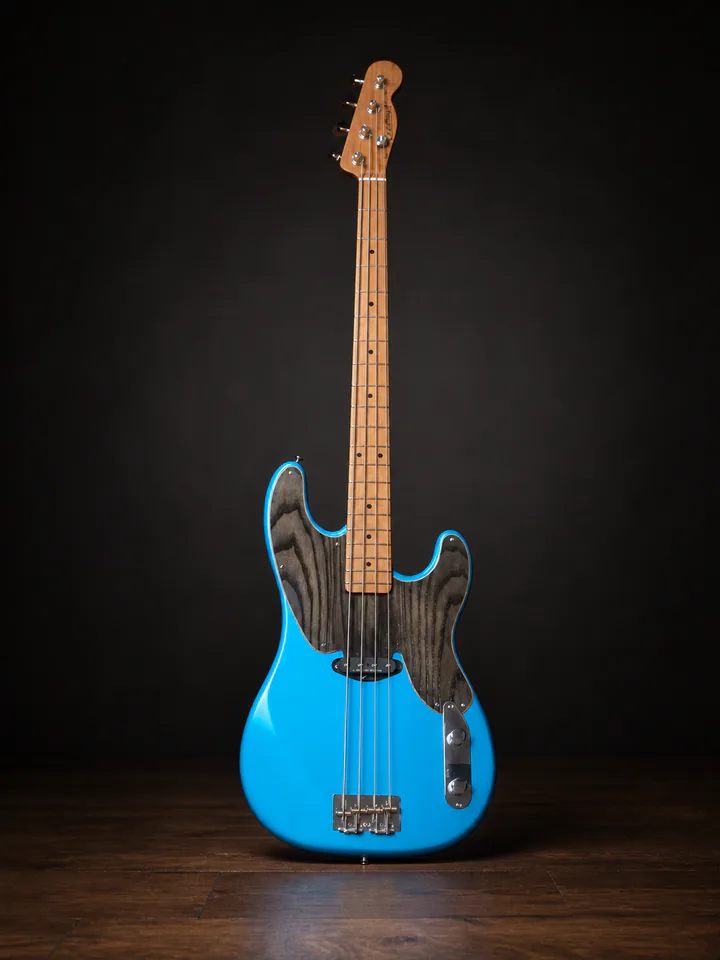 Blue four-string Caldwell custom instrument on a professional studio background