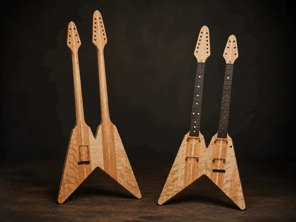 Matched unfinished double-neck V guitars on a professional studio background
